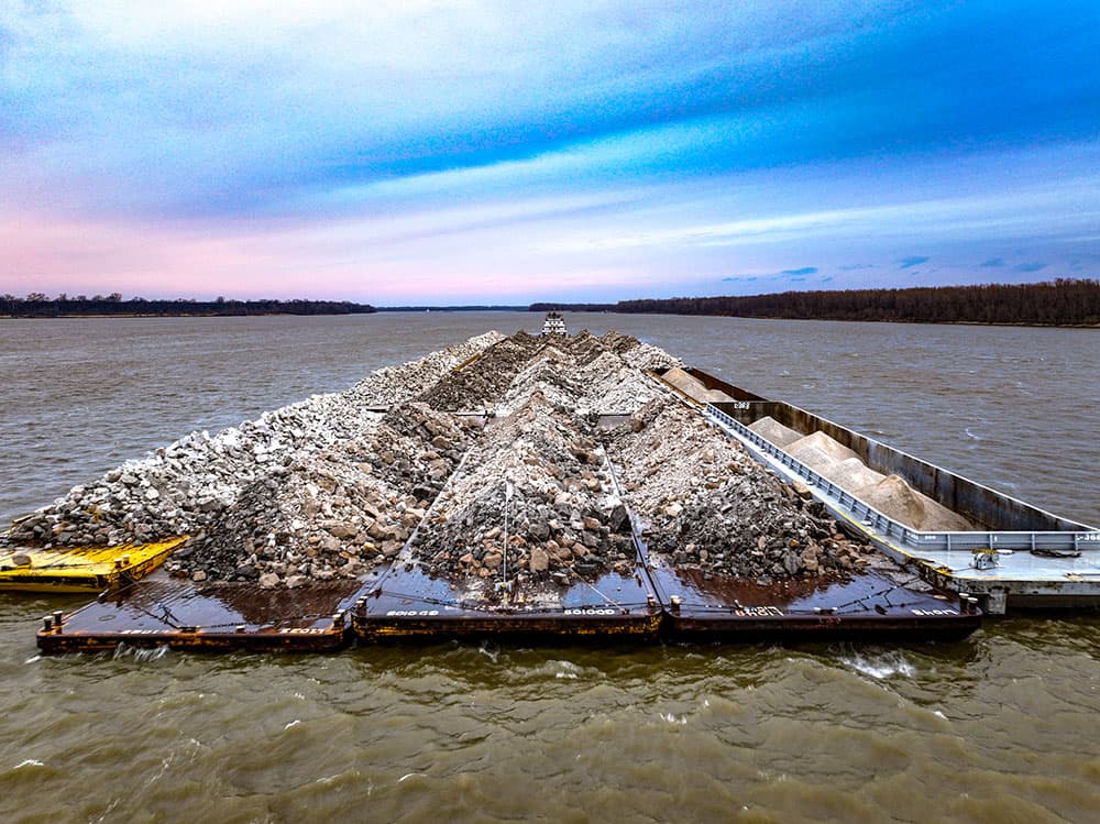 barges hauling rock down the river
