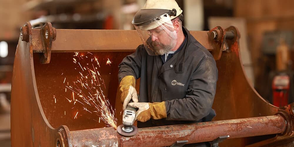 Welder working on equipment repair